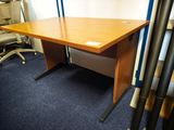 une photo d'un bureau dans un bureau, avec une chaise en arrière-plan