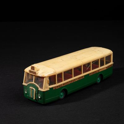 a toy bus that is sitting on a black surface