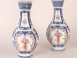 pair of blue and white vases with floral designs on them