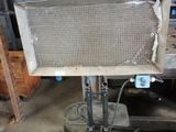 a large piece of metal on a stand in a warehouse