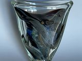 a glass vase with a blue and black design on it