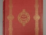 an old red book with gold trimming and a gold border