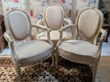 three chairs that are sitting on a rug in a room