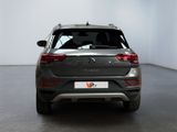 the rear end of a grey volkswagen suv parked in a white room
