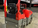 a small red machine that is parked in a garage