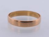 a close up of a gold ring on a white surface