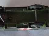 a green toy train with wheels on a white surface