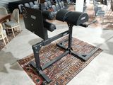 a black machine that is sitting on a rug in a room
