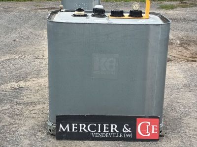 a metal box with a clock on top of it in a parking lot