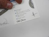 a person holding a pair of scissors over a piece of paper