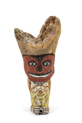 a wooden figurine of a man with a hat on it ' s head