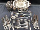 a lot of silverware and silverware on a table