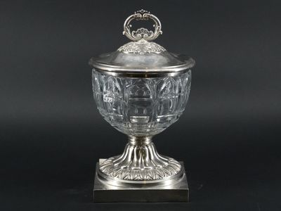 an antique silver plated bowl with a lid on a stand