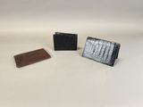 three different types of wallets on a white surface