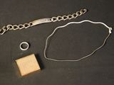 a bracelet, ring, and bracelet chain on a table