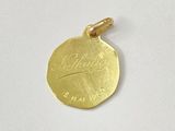 a gold plated coin with a leaf on it