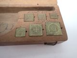 an old wooden box that has a lot of stamps on it