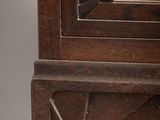 a wooden cabinet with a mirror on top of it
