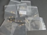 a lot of bags with screws on them on a table
