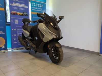 a black and silver motorcycle parked in a showroom