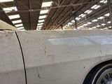 a white car that is parked inside of a building