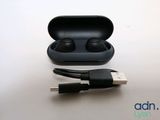 an image of a pair of ear buds sitting on top of a charging case