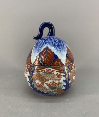 a blue and white bell with a bird on it