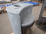 a trash can sitting on a pallet next to a stove