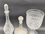 three pieces of glass sitting on top of a table next to each other