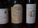 several bottles of wine are lined up on a table