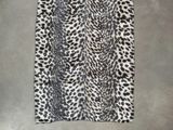 a white and black leopard print skirt on a hanger