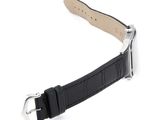 the black leather strap has a silver buckle on it