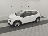 the small white car is parked in the garage on the checkered floor