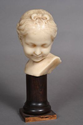 a white marble bust of a boy on a wooden base