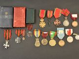 an assortment of medals and medals are displayed on a table