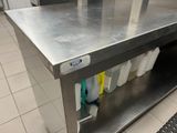 a stainless steel table with two buckets on top of it