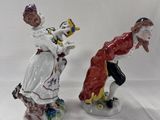 two figurines of a man and a woman on a white background