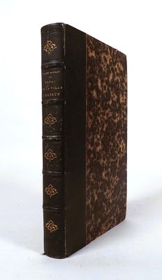 an old book is sitting on a white surface with a white background