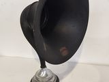 an image of a black and silver lamp on a white surface