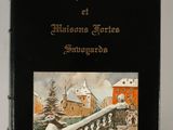 an old book with a picture of a town in the background