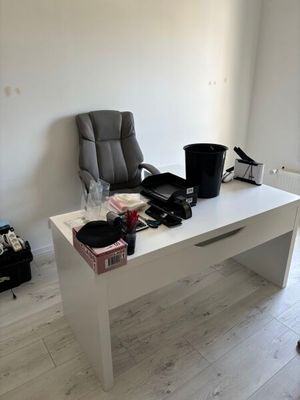 a desk with a chair and a chair in a room