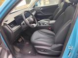 the interior of a blue car with black leather seats and a steering wheel