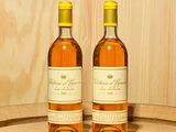 deux bouteilles de vin posées sur un tonneau
