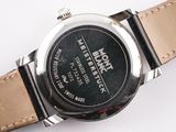 a close up of a watch on a white surface