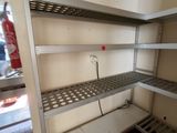 a metal shelf in the corner of a room