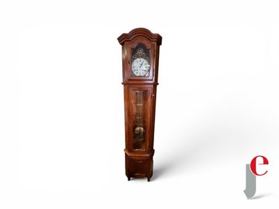 a grandfather clock that is standing on a white surface