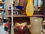 many different vases on a table in a store