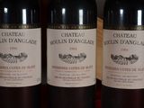 three bottles of wine sitting on top of a table next to each other