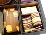 a wooden box filled with assorted items on a table