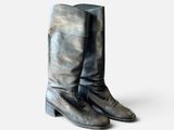 vintage black leather cowboy boots on a white background